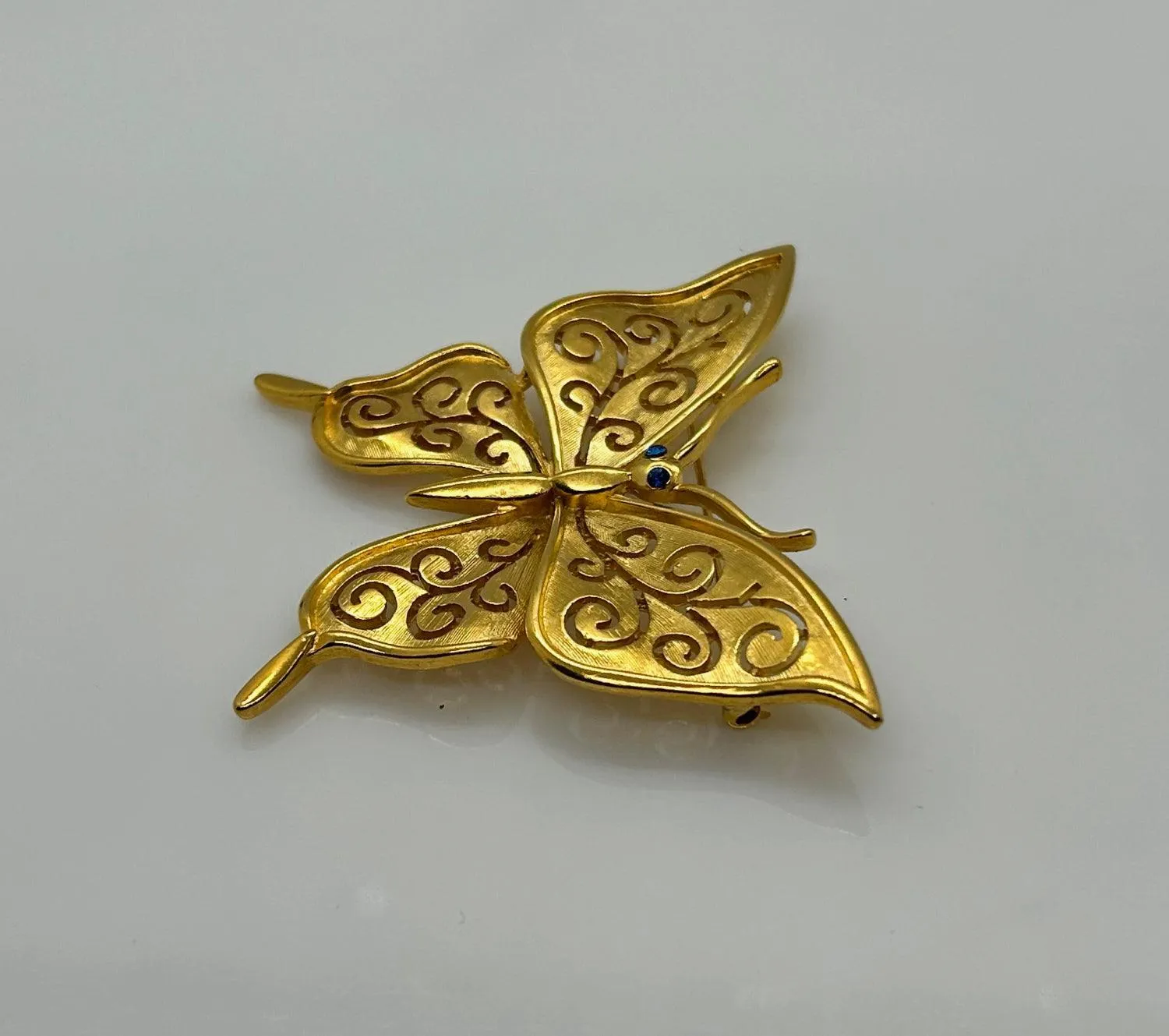 Crown Trifari Gold Tone Filigree Butterfly Brooch with Blue Eyes