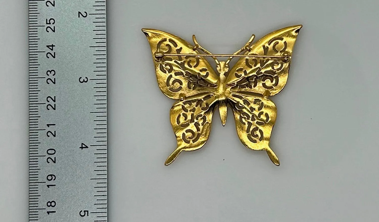 Crown Trifari Gold Tone Filigree Butterfly Brooch with Blue Eyes